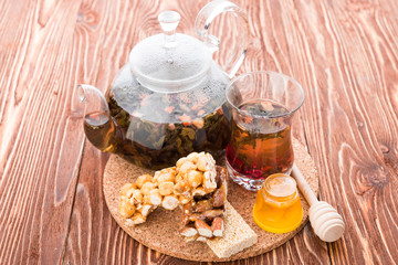 exotic green tea with flowers in glass teapot