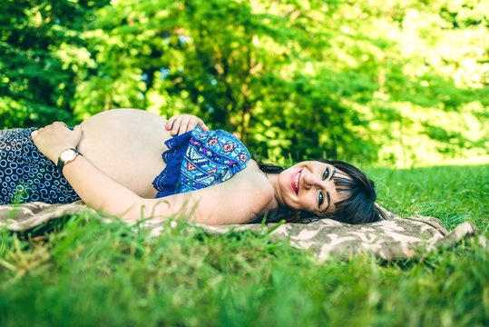 Pregnant woman relaxing outdoor in the park