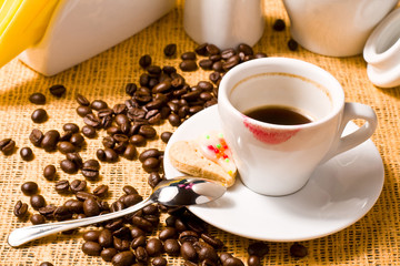Cup of tested coffee with track of red lipstick