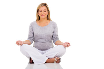 peaceful pregnant woman meditating