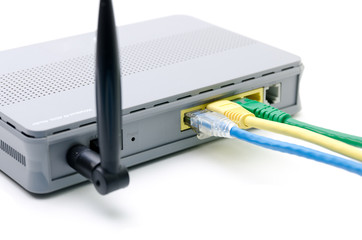 Closeup of network cables connected to wifi router on white