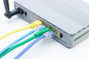 Closeup of network cables connected to wifi router on white