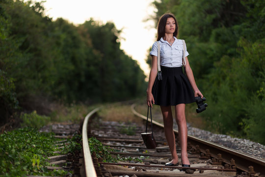 Girl walking on railway line