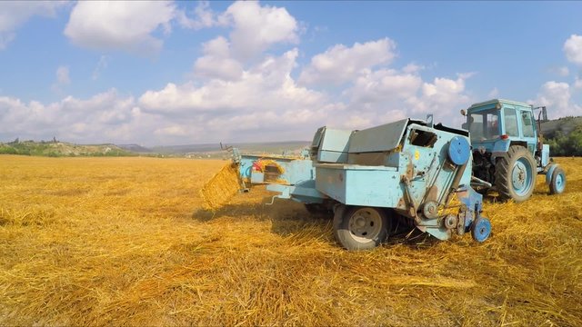 Tractor Baler Making Fresh Bale During Harvesting