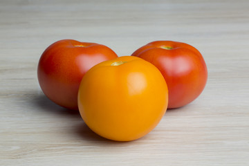 tomatos lying on a wooden background