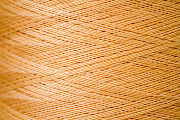 Close up of a Spool of Synthetic Orange Thread