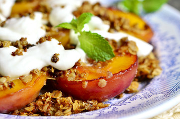 Grilled peachs with granola and whipped cream.