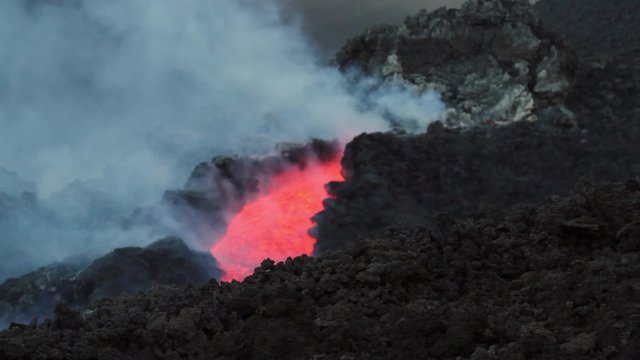 Lava flowing within a channel. Mount Etna eruption