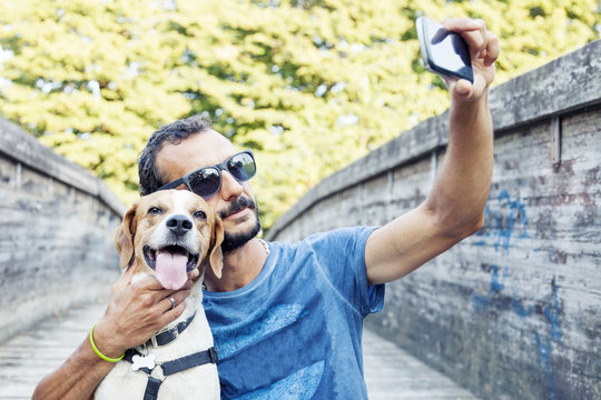 Young Man Takes A Selfie With His Dog