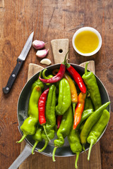 cooking fried hot peppers. Italian vegetarian dish. with olive o