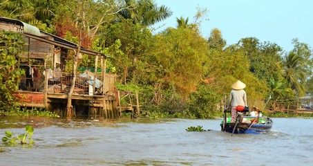 Can Tho, Vietnam - 5 March 2015: Woman moving by rowing boat, the most common transportation mean of rural people in Mekong delta Vietnam