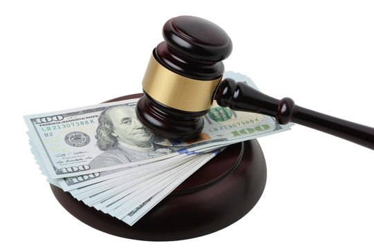Gavel with dollars on a white background