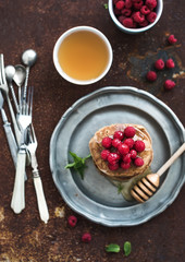 Breakfast set. Buckwheat pancakes with fresh raspberries, honey