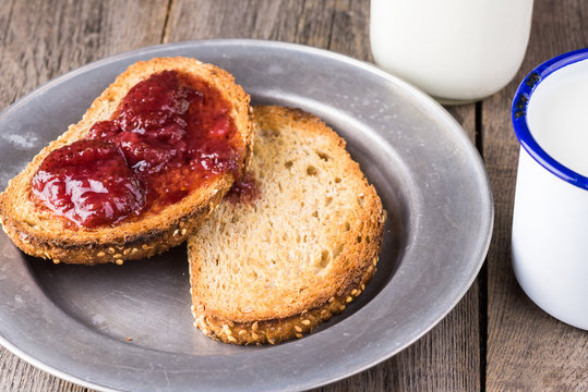 Toasted pieces of bread with strawberry jam.