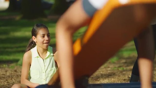 Young girl on a see-saw in a park
