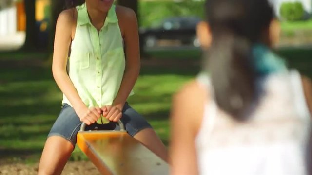 Young girl on a see-saw in a park
