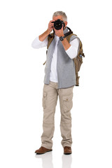mature male tourist taking pictures