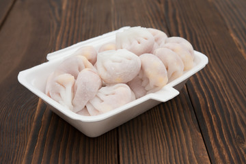 homemade dumpling filled with meat and corn on wooden board