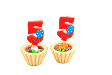 cakes with fifty five years birthday candles on white