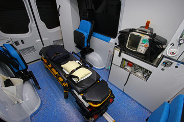 Interior of a modern ambulance with stretcher,heart monitor,defibrillator,oxygen,lights,night...