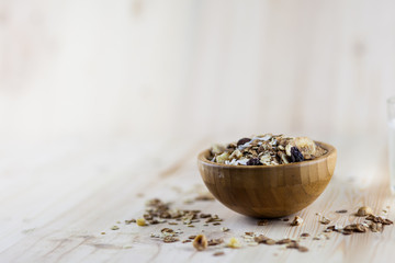 Muesli and granola in blurred wooden background. (Shallow aperture intended for  the aesthetic quality of the blur.)