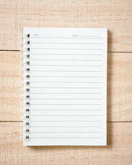 Notebook on wood background.