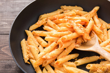 Penne pasta with tomato sauce in a pan