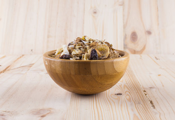 Bowl of muesli on wooden table and backgroundฺ