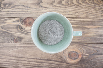 hot coffee cup on wood table Focus on coffee powder