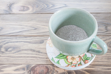 hot coffee cup on wood table Focus on coffee powder