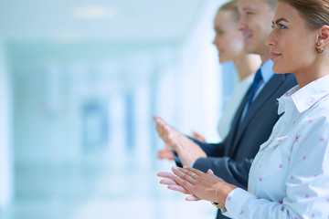 Smiling business people applauding a good presentation in the