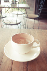 Hot Chocolate.Placed on a wooden table in a coffee shop.