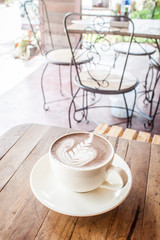 Hot Chocolate.Placed on a wooden table in a coffee shop.