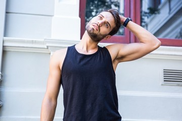 Handsome athlete stretching his head