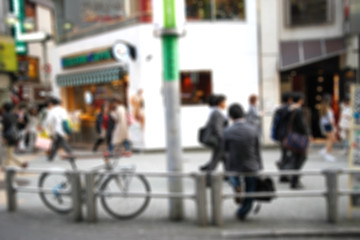 blur of businessman sitting on sidewalk