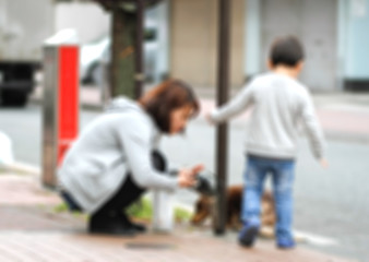 blur of mother and son on sidewalk