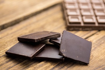 Pieces of chocolate on a wooden table