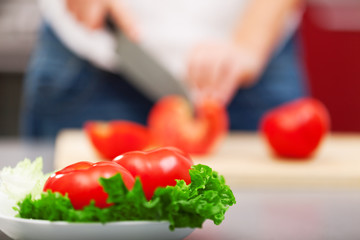 Young woman making salad