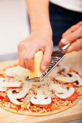 Young woman preparing pizza