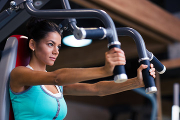 Fototapeta premium Woman workout on exercises machine
