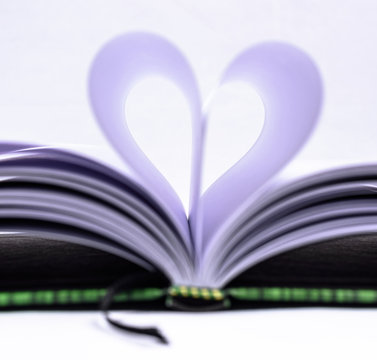 Heart Shaped Book. Book page in heart shape, focus on foreground.