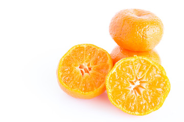 Orange on white plate put on wooden table.