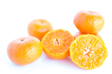 Orange on white plate put on wooden table.