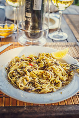 Pasta with meat on white plate.