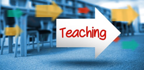 Teaching against volumes of books on bookshelf in library