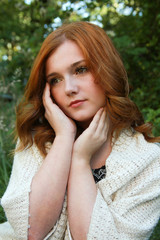 Naklejka premium Beautiful young woman with red hair day dreaming