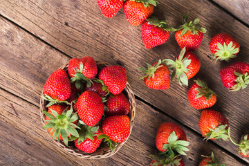 Fresh red strawberries on old wooden background