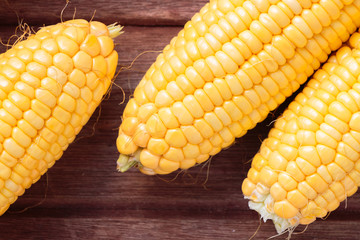 Fresh sweet corn on wooden background