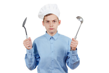 Young cheerful teenager with ladle and humor in a chef's hat. Isolated studio