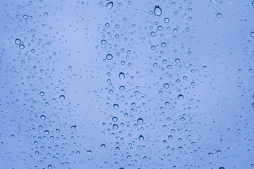 Close-up of water drops on glass surface as background.